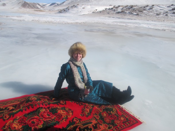 Drinking coffee on a carpet on a frozen river