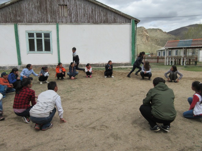 Playing a game similar to duck duck goose during Friendship time